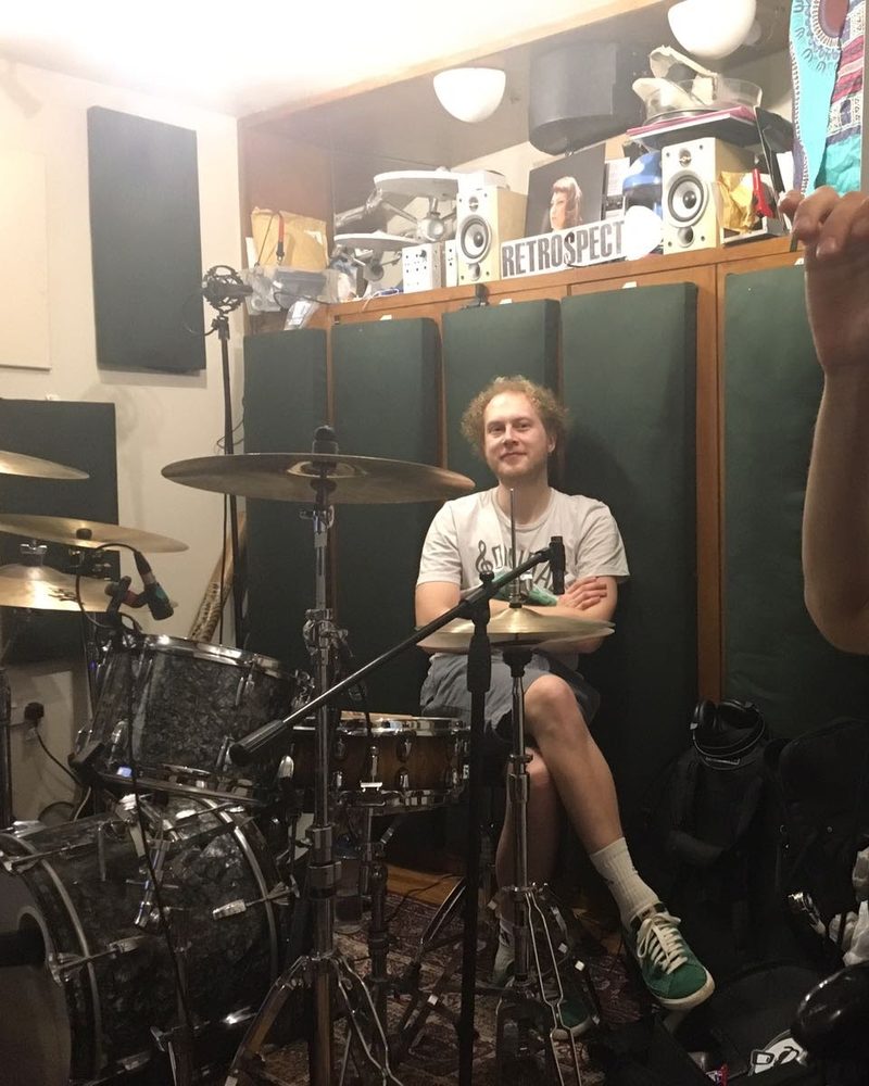 Jack sitting at a drum kit in a recording studio