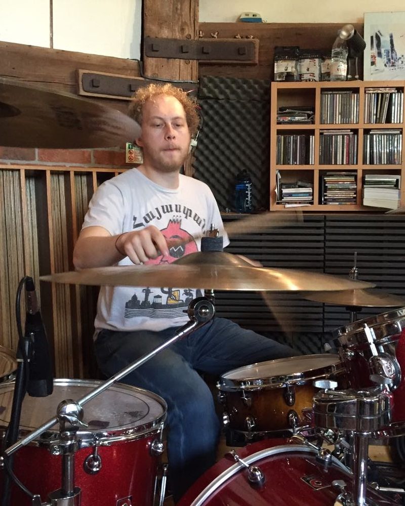 Jack playing drums in a recording studio