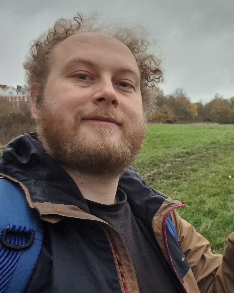 Jack giving a peace sign on a walk across a field